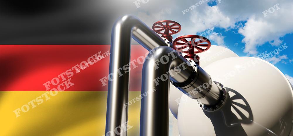 Изображение газопровода с красными вентилями и резервуарами на фоне флага Германии, символизирующего значимость газовых поставок для страны. Фотография подчеркивает роль импорта топлива в энергетической безопасности и инфраструктуре Германии.
